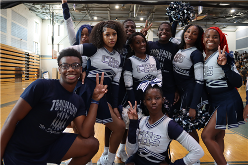 Students that Cheerleaders smiling  in the gym for the Pep Rally.
